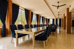 a conference room with a long table and chairs at The Four Season Resort, Mussoorie - top rated & most awarded property in mussoorie in Mussoorie