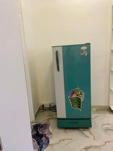 a green and white refrigerator sitting in a room at Coastal Bliss in Dickwella +45 photos