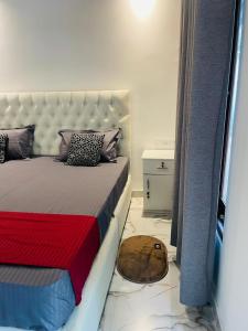 a bedroom with a bed with a red and blue blanket at Coastal Bliss in Dickwella