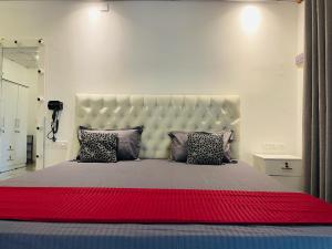 a bedroom with a large bed with a large headboard at Coastal Bliss in Dickwella