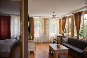 a living room with a couch and some windows at Laguna Villa Cottages in Chinkadzeebi +40 photos