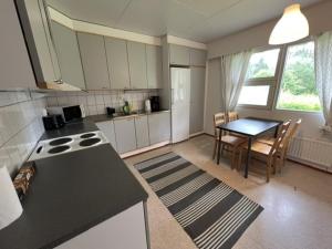 a kitchen with a table and a dining room at Ravikatu, Oulainen, in Oulainen
