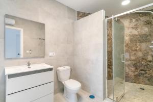 a bathroom with a toilet and a glass shower at Bender House in Moralet +24 photos