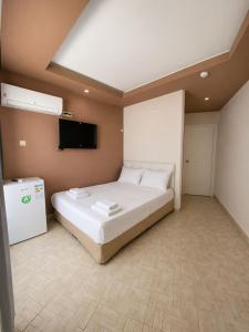 a bedroom with a bed and a flat screen tv at Atlas Butik Otel in Kizkalesi +18 photos
