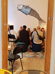 a group of people sitting in a room at Goodnight Hostel in Lisbon