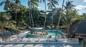 a pool at a resort with people in it at Tiki Beach Economy in Paje
