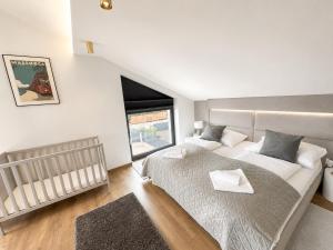 a bedroom with a large bed and a window at Villa Porta Verde IV - Infinity pool BBQ Luxury in Balatonalmádi +19 photos