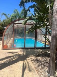 a house with a swimming pool in a glass enclosure at Danitsea vila in Larnaca
