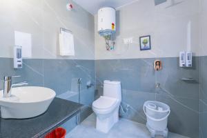 a bathroom with a white toilet and a sink at The Ganga lodge, Manali - Affordable Luxury Stay Near Mall Road Manali in Manāli