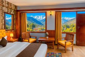 a hotel room with a bed and a view of mountains at The Ganga lodge, Manali - Affordable Luxury Stay Near Mall Road Manali in Manāli +31 photos