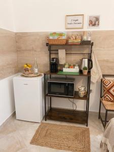 a kitchen with a microwave and a small refrigerator at Gioia B&B in Cirò Marina