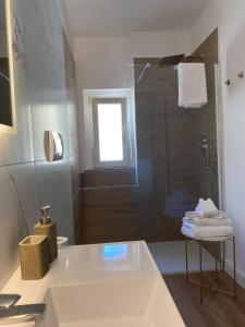 a bathroom with a shower and a sink and a tub at Residenza Vittoria in Petacciato