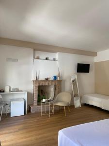 a living room with a bed and a fireplace at Residenza Vittoria in Petacciato