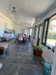 a large living room with a table and chairs at Casa Rodica in Mangalia