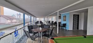a dining room with tables and chairs and a balcony at Delta Palace in Sulina