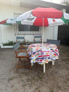 a table and chairs under an umbrella in a yard at Yayi Maria in Río Hato +6 photos