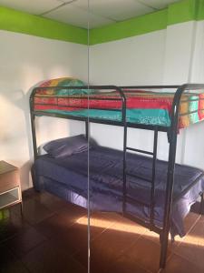 a bunk bed in the corner of a room at Yayi Maria in Río Hato