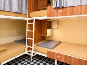 a room with two bunk beds and a checkered floor at Vang Vieng Dragon House in Vang Vieng +39 photos