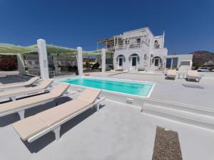 a villa with a swimming pool and a house at The Cliff Reflections - Adults Only in Megalochori