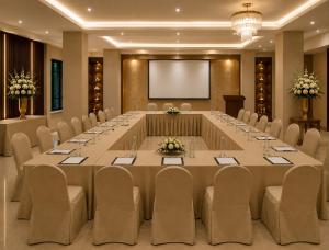 a large conference room with a large table and chairs at Hotel ZP Grand in Bhilai