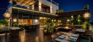 an outdoor patio with tables and chairs and a building at Hotel ZP Grand in Bhilai