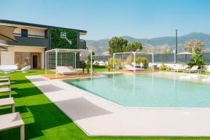 a swimming pool with chairs and a house at Heaven Room in Striano