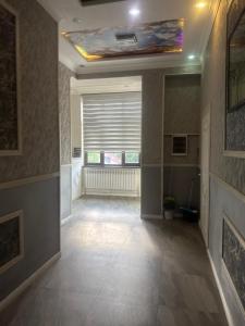 a hallway with a room with a window and a ceiling at Rodnik in Almaty