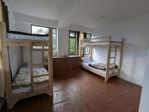 a room with two bunk beds in it at Mochilero Homestead in Pelling +7 photos
