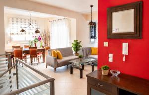 a living room with red walls and a dining room at Holiday Lefkas Moonlight Luxury Appartments in Nikiana