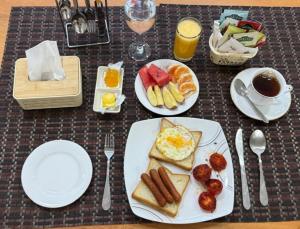 a table topped with plates of breakfast foods and drinks at Dee Holidays in Moratuwa