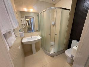 a bathroom with a shower and a sink and a toilet at PracticOtel Kyiv in Kyiv +44 photos