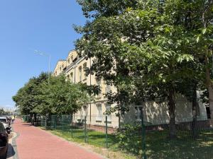 a building on the side of a street with trees at PracticOtel Kyiv in Kyiv