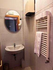 a bathroom with a sink and a mirror at Hotel Adua in Venice +10 photos