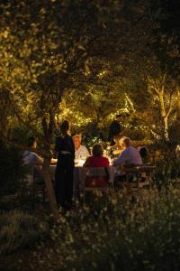 a group of people sitting at a table in a park at Amagatay Luxury Boutique Hotel - Adults Only in Alaior
