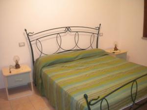 a bed in a bedroom with two nightstands and two tables at Le case in collina - San Teodoro in Lu Lioni +79 photos