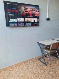 a table and chairs and a poster on a wall at The Greenergy - NO LIFT - Book 48 hrs ahead - 4th floor in Hat Yai +9 photos