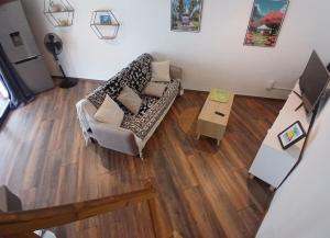 an overhead view of a living room with a couch and a table at Bungalow P&P in Entre-Deux +1 photo
