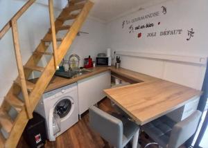 a kitchen with a table and a washing machine at Bungalow P&P in Entre-Deux