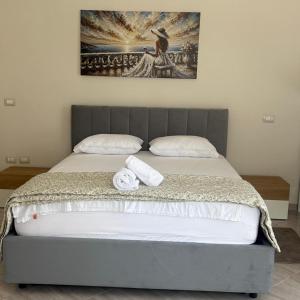 a bed with two towels sitting on top of it at Star Apartment 2- Spacious in the heart of Durres in Durrës