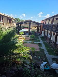 a courtyard of a building with a yard with plants at Fantasia do Agreste in Jandaíra