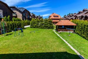 a yard with a playground and a house at Apartment Vila Simovic in Zlatibor
