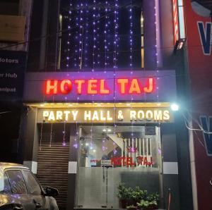 a hotel tar sign on the side of a building at Hotel Taj in Pānīpat