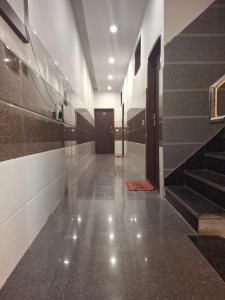 a hallway with stairs and a door in a building at Hotel Taj in Pānīpat