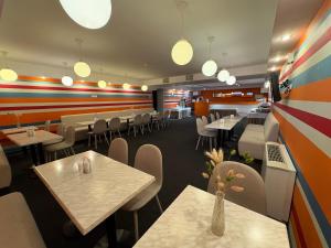a restaurant with tables and chairs and lights at PracticOtel Kyiv in Kyiv