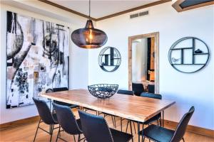a dining room with a wooden table and chairs at Tremblant Prestige - Équinoxe 164-2 in Mont-Tremblant