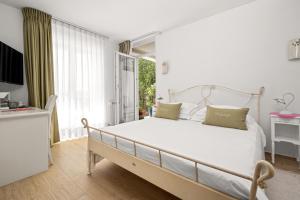 a bedroom with a large white bed and a window at VILLA STEFANIJA small Boutique hotel&restaurant in Barban