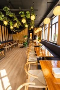 a dining room with wooden tables and chairs at Hotel Olimp in Cluj-Napoca