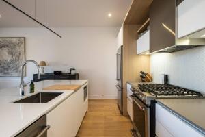 a kitchen with a sink and a stove at Tremblant Prestige - Verbier 3-201 in Mont-Tremblant