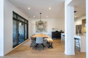 a kitchen and dining room with a wooden table and chairs at Tremblant Prestige - Verbier 3-201 in Mont-Tremblant