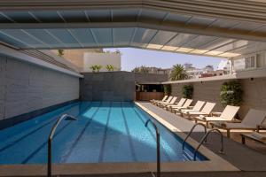 a swimming pool on the roof of a building at Idou Anfa Hôtel & Spa in Casablanca
